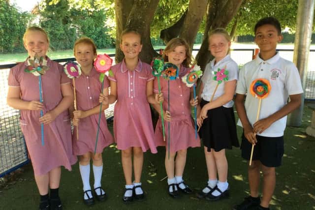 Georgian Gardens Community Primary School pupils with the flowers they made for the summer display