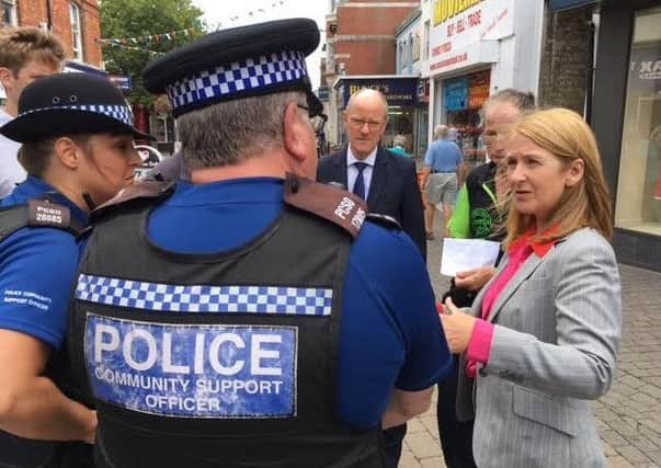 Police and crime commissioner Katy Bourne, right, with Nick Gibb MP, centre, and Tyndall Jones, wearing green, in Littlehampton town centre