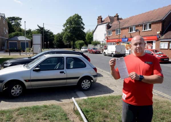 ks180378-3 Chichester Drive Ticket  phot kate
Peter Dallaway with the parking ticket he received for having a car parked on the driveway to his house.ks180378-3 SUS-180608-182338008
