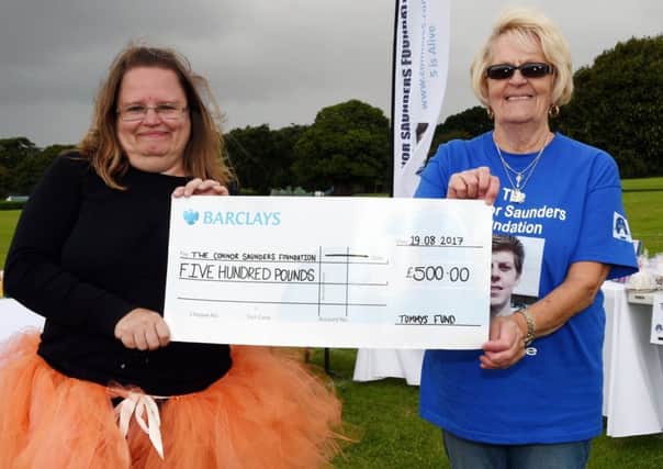 Jeanette Compton hands over a cheque of Â£500 at last year's event