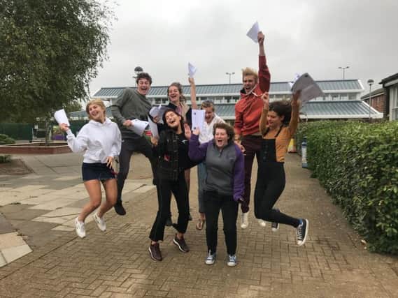 Students jump in joy after receiving impressive exam results