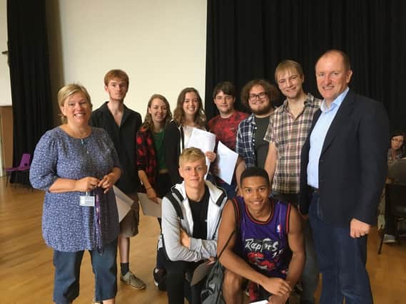 Rob Carter, headteacher and Hilary Morfitt with students celebrating their results at the college today
