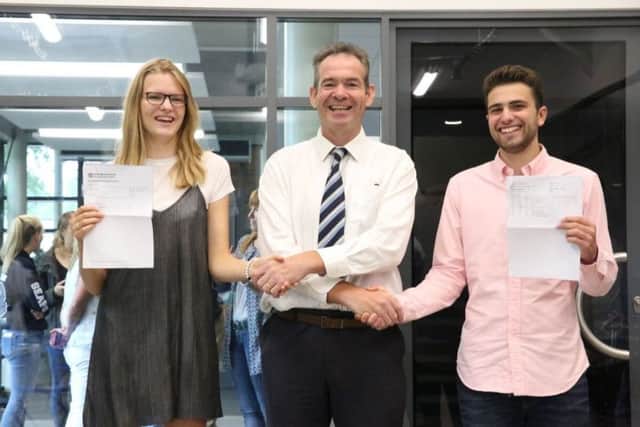 Headmaster John Green celebrating Seaford's best ever A Level results with Ruby Pritchard and Tom Hennessy. Picture contributed