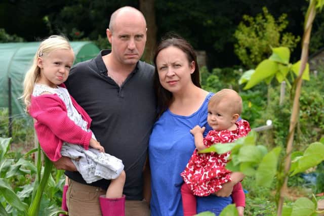 Duncan and Christina Milham at their Haredean allotment with daughters Bramble and Amora