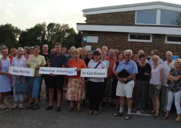 Rudwgick residents outside a parish council meeting opposing two proposed new housing estates next to Cox Green (photo submitted).