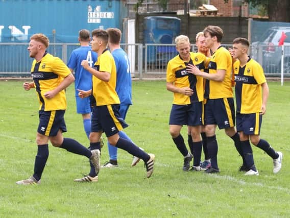 Town players celebrate Evan Archibalds goal against Shoreham. Picture by Joe Knight
