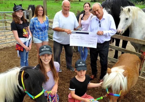 Nigel Mundy Founder of Pagham Ponies (fourth from left) receives a cheque from Thompson Civil Engineering's owner Tommy Thompson for ?1000 from friends and himself.  Pic Steve Robards SR1822089 SUS-180822-190310001