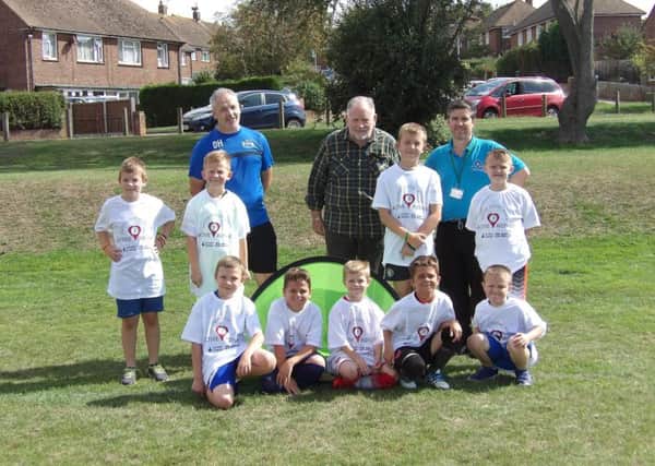 Youngsters at one of the football coaching sessions at Sidley Recreation Ground with (from left) football coach Darren Horsman, Cllr Jim Carroll and Adrian Gaylon from Rother District Council SUS-180829-095644001