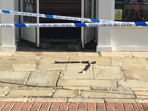 Crowbars on the ground outside the shop