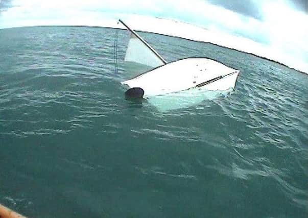 Capsized sailing boat. Picture contributed