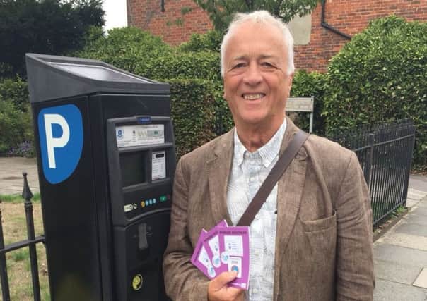 Chichester BID chairman Colin Hicks with on-street parking vouchers.