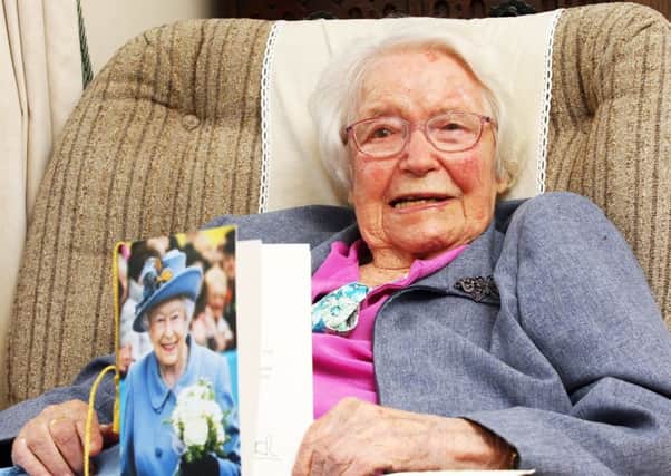 Centenarian Gwendoline Kippin with her card from the Queen. Photo by Derek Martin DM1884172a