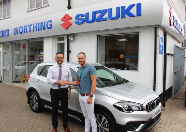 Mark Davis, dealer principal at Worthing Suzuki, and Scott Morgan, assistant facilities manager at St Barnabas House hospice with the new Suzuki S-Cross