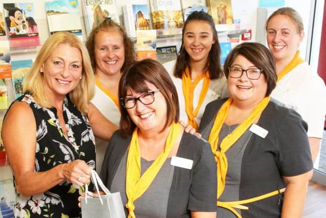 Travel agent Judy Osborne has worked in Thomas Cook in Rustington for 40 years. Pictured, centre, with colleagues. Photo by Derek Martin Photography