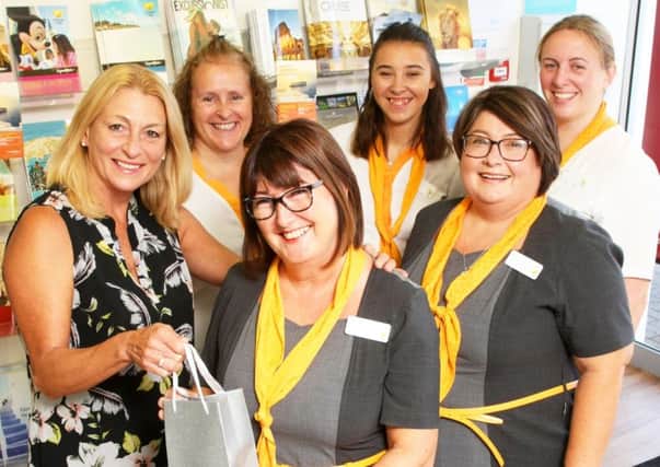 Travel agent Judy Osborne has worked in Thomas Cook in Rustington for 40 years. Pictured, centre, with colleagues. Photo by Derek Martin Photography