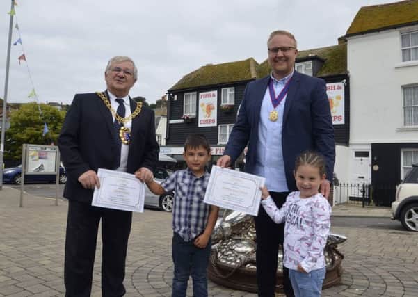 Hastings Mayor Cllr Nigel Sinden and deputy Mayor James Bacon award prizes to Harry and Amelia Dean for their hard work at the Hastings Old Town fancy dress litter pick, SUS-180409-094056001
