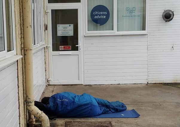 A person in a sleeping bag outside Eastbourne Citizens Advice