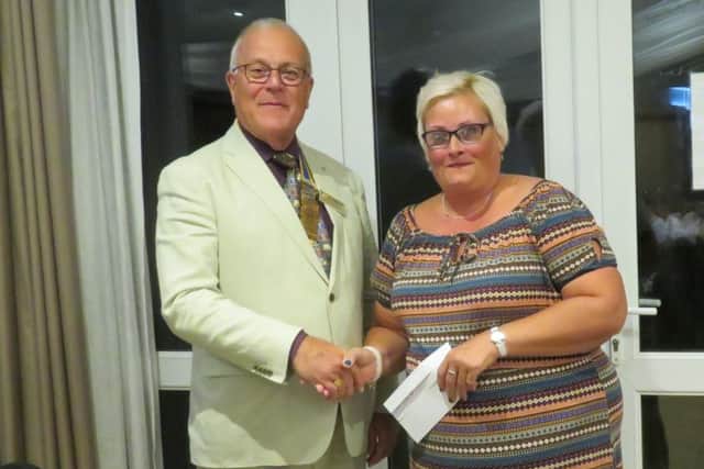The Rotary Club of Senlac President Dave Miles presents a cheque to Sarah Vaughan-Cox of the Parchment Trust SUS-180409-124151001