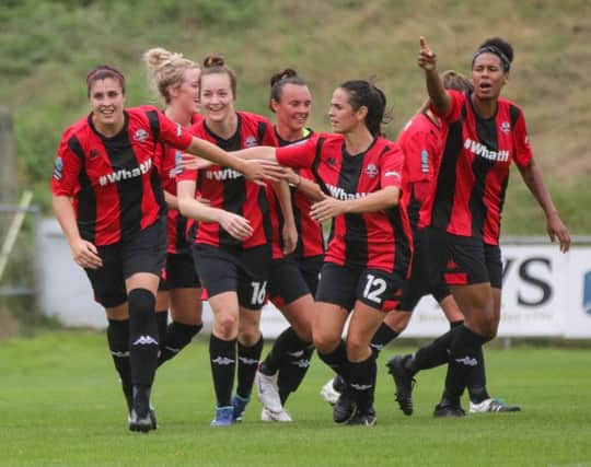 Lewes team-mates congratulate Dani Lane (left) who scored twice in the 5-0 victory over Charlton Athletic