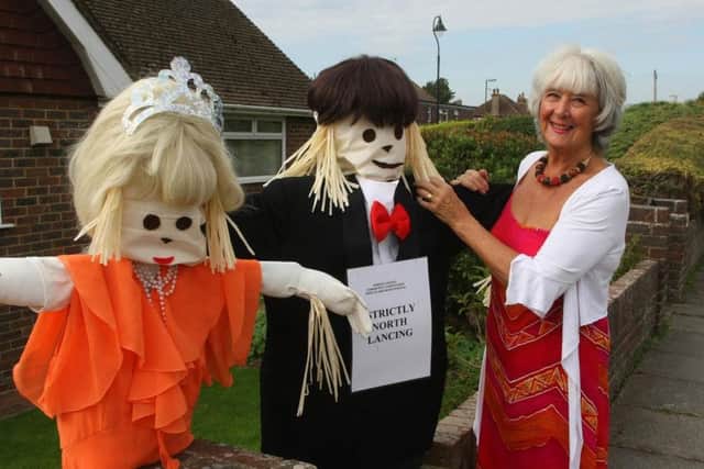 Maureen Ross with her scarecrows