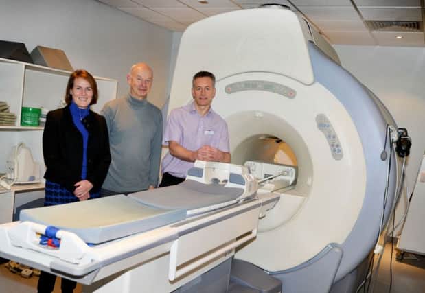 Dr Lesley Apthorp, Dr Richard Wray and Chris Brandt, Superintendent Radiographer, with a scanner from 2004