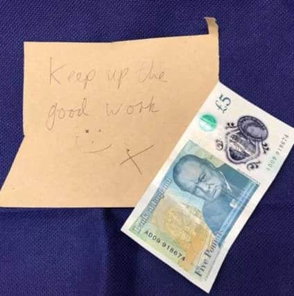Paramedics Gareth Pryor and Tom Barlow were shocked to find this Â£5 note and message left on their ambulance windscreen