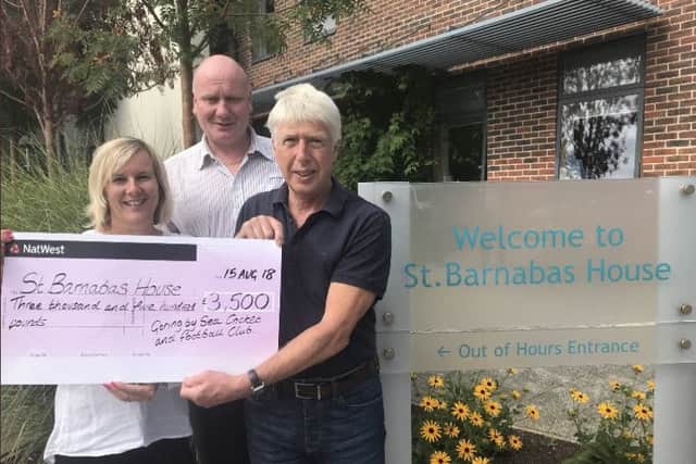 Debbie Freeman, Andy Masson and Steve Davies at St Barnabas House hospice to hand over the cheque