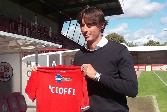 Gabriele Cioffi holding a Crawley Town shirt