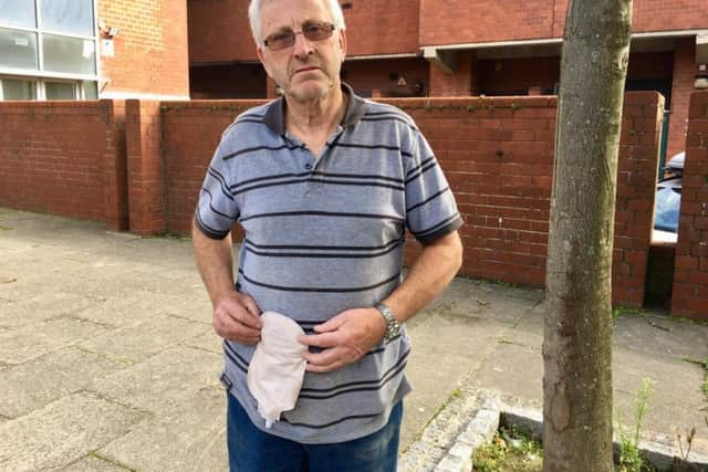 John McCartney, 70, from Boundary Road, Lancing, holding one of his catheter bags and flanges outside the place that he parked in Chatsworth Road, Worthing, behind the wall