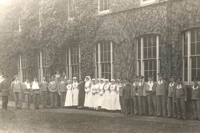 Nurses with soldiers from the First World War. Picture from West Sussex County Library Service - www.westsussexpast.org.uk/Pictures SUS-181009-153924001
