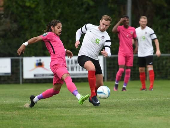 Horsham YMCA's Ollie Moore in action in their FA Cup first qualifying round defeat to Tooting & Mitcham. Picture by Liz Pearce.