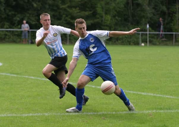 Patrick O`Sullivan (blue) scored twice for Roffey FC. Photo by Clive Turner