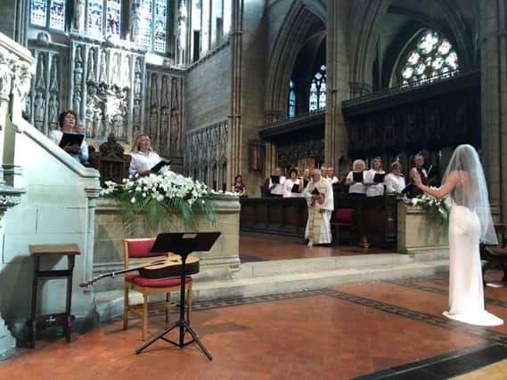 Christabel leading the choir in her wedding dress during the ceremony