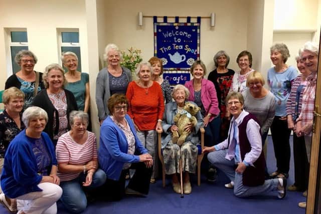 Jen Jennings from Pulborough with her friends from the Crafe CafÃ© after being presented with her childhood bear for her 100th birthday SUS-181209-151120001