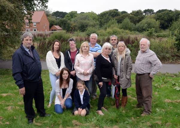 Councillor English, left, with residents concerned about the development proposed for the land behind them. Photograph: Kate Shemilt/ ks180449-1