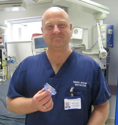 Photo shows Dave Fox-Dossett holding an iTClamp SUS-140804-131216001