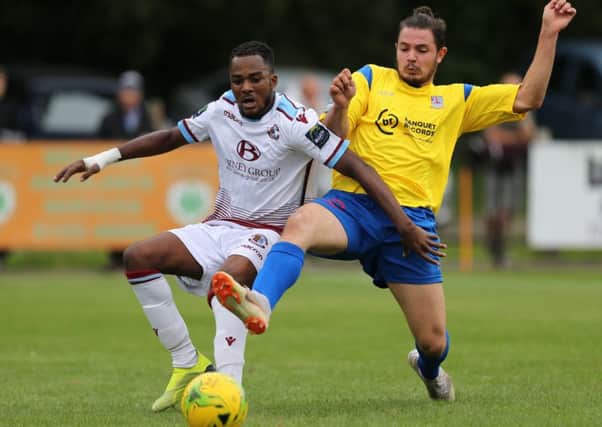 Kelvin Ogboe tries to hold off an opponent during Hastings United's 2-1 win at home to Kingstonian last weekend. Picture courtesy Scott White