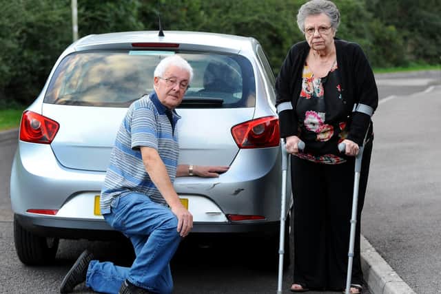 Graham White and his wife Pat were left in shock by the collision which left the rear bumper of their car dented and the reflector light broken. Picture by Sarah Standing