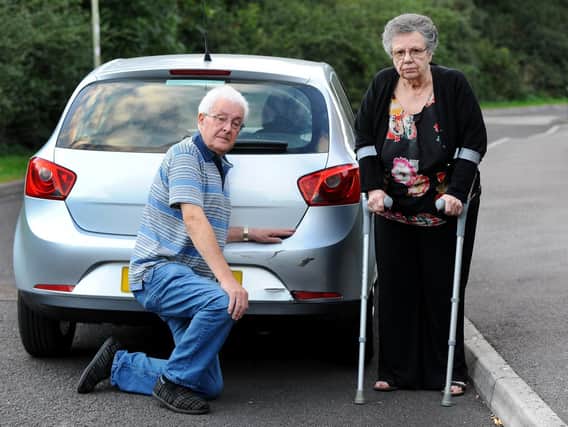 Graham White and his wife Pat were left in shock by the collision which left the rear bumper of their car dented and the reflector light broken. Picture by Sarah Standing
