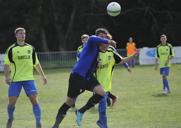 Hollington United forward Dom Clarke goes up for a header against Peacehaven & Telscombe II. Pictures by Simon Newstead