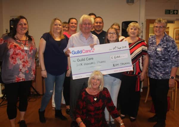 Adam pictured with his grandad, niece, family members and Guild Care staff