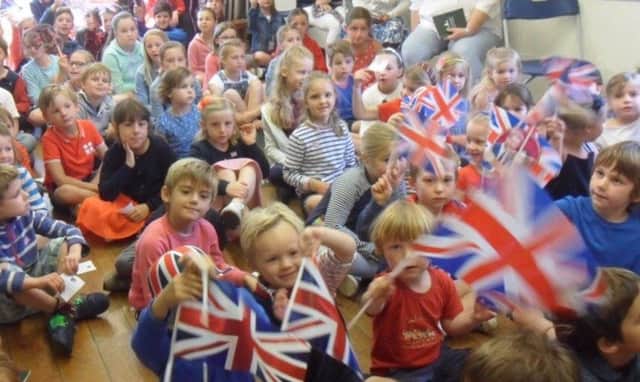 Children at Conifers School, Easebourne, celebrate the wedding of Prince Harry and Meghan Markle SUS-180521-165912001
