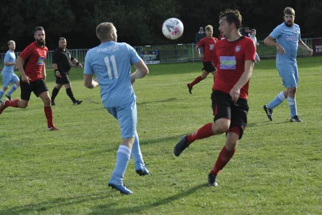 Rye Town and Robertsbridge United tussle for possession at Gibbons Field.