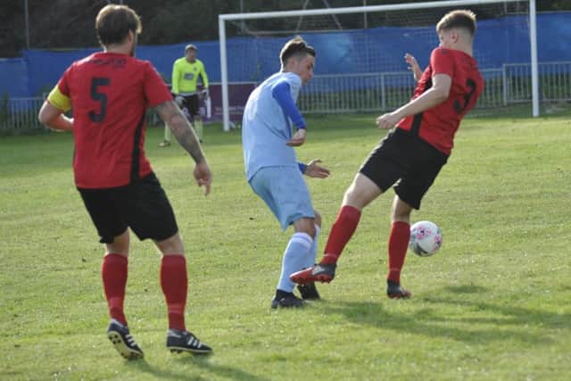 Rye Town's Joe Fraser and Robertsbridge United's Curtis Coombes compete for the ball.