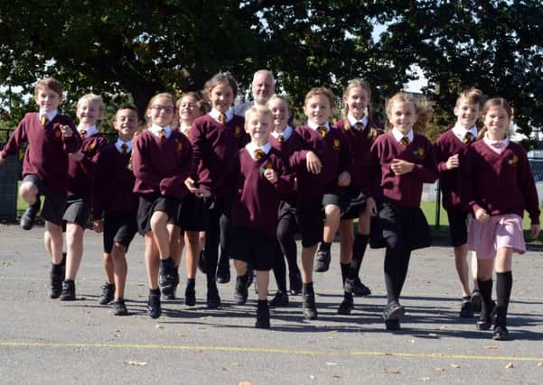 Headteacher of Nyewood C of E Junior School Mr Jon Williams and pupils delighted with the Ofsted report. Photograph: Kate Shemilt/ ks180470-1