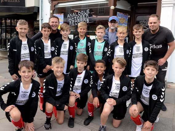 The team show off their new kits outside the record shop in South St / Picture by Kate Shemilt
