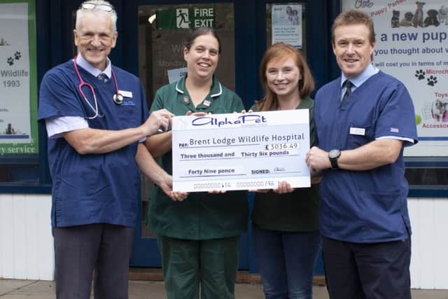 Doug Alexander and Nurse Charlie Sampson, presented the giant cheque to Emma from Brent Lodge