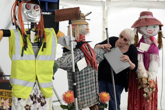 Marian Dye judging the scarecrow entries for the Littlehampton Town Show competition. Picture: Kate Shemilt