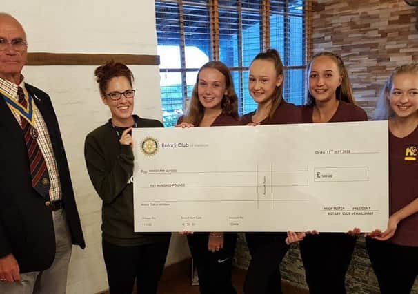 Dancers from Hailsham Community College recieve cheque from the Rotary club towards Disney dance trip SUS-180926-110006001