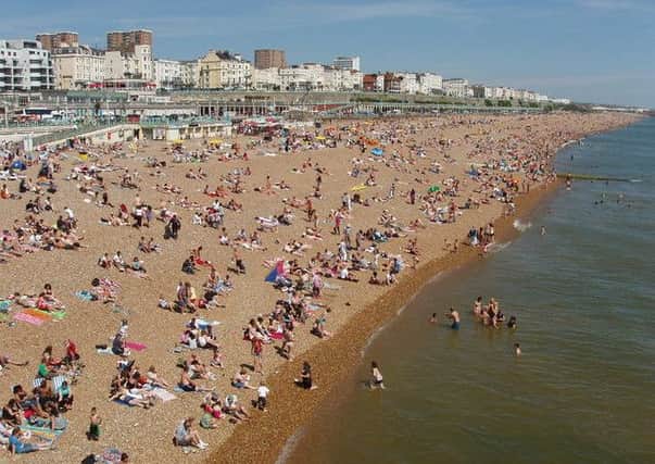 Crowded Brighton beach east of Palace Pier - Â© David Hawgood licenced by Creative Commons